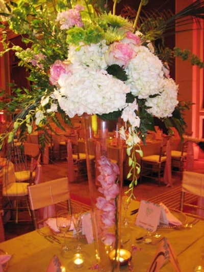 The three-foot-tall arrangements from Grand Floral & Design filled clear glass vases with ferns, orchids, hydrangeas, pink roses, and ivy.