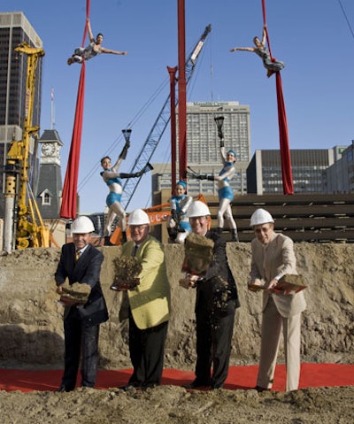 Aerial acrobats from Circus Orange performed at the groundbreaking ceremony while officials posed for photographs on the construction site.