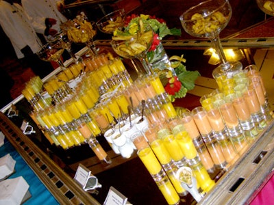 An assortment of gazpacho shots and ceviche on a mirrored tabletop were served during the cocktail reception.