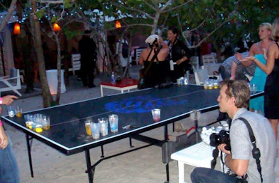 Branded beer pong tables set up on the beach drew the attention of partygoers and photographers alike.