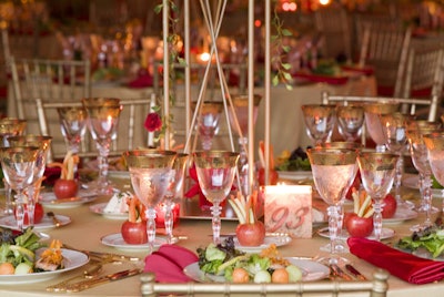 Each place setting featured ivory and gold dinnerware and French stemware.