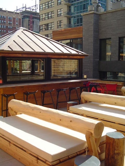 Sleek elements such as long wooden benches and a dual-sided fireplace give Zed451's rooftop lounge a streamlined look.