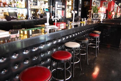 Vintage candlesticks and lamps decorate the main bar, which is faced in quilted leather.