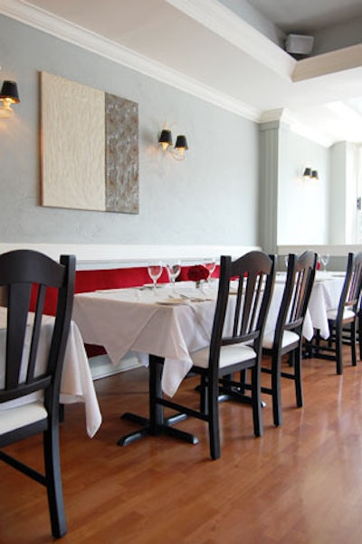Plush red banquettes provide seating along one wall of the restaurant.