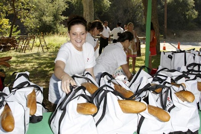 Upon arriving, guests received cotton picnic totes stuffed with baguettes, olives, cheese, and salads.