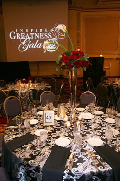 Three-foot-tall arrangements of roses and calla lilies topped the innermost dinner tables.