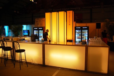 An illuminated bar inside the Pricewaterhouse Coopers V.I.P. Lounge offers Corona and California wines to guests.