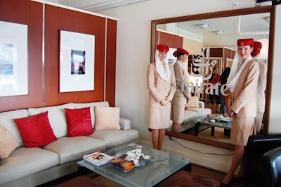 The Emirates Airlines suite includes a large mirror bearing the company logo, artwork on loan from the Art Gallery of Ontario, a sushi bar, and flight attendants dressed in uniform.