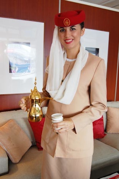 Flight attendants offer Arabian coffee to guests inside the Emirates Airlines suite.
