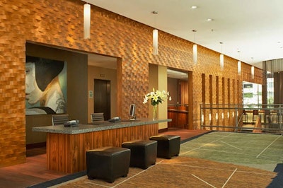 The Dana Hotel and Spa's reception area features sustainable woods found throughout the property and a sleek, contemporary look. Guests can check in at the front desk or at express kiosks.