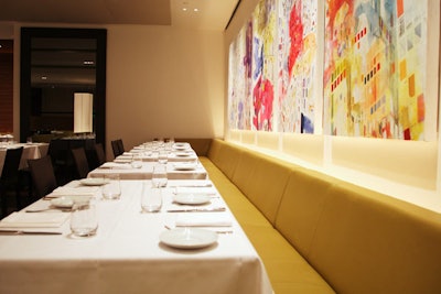 Paintings by artist Alex D'Arcy add colour to the dining room.