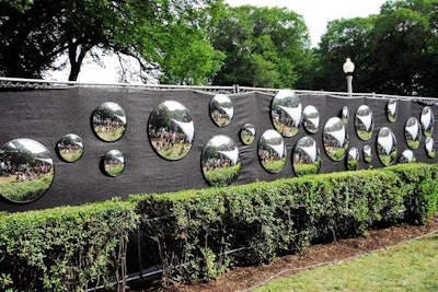 Rearview mirrors lined a fence separating the park from Columbus Drive.