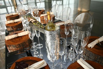 On the mirror-topped table more visuals included wooden chargers, a tray filled with berries and leaves, and leaves used a place cards.
