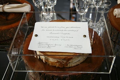 The invitation, a piece of birch inside a Plexiglass box, was designed to imitate the room—a glass box with a sliver of nature inside.