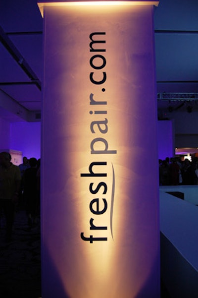 After the room darkened for the runway show, spotlights illuminated Freshpair.com's branded pillars throughout Espace.