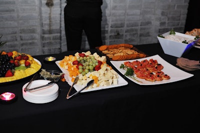 A selection of passed appetizers and a spread of fruits, cheese, and crackers were served.