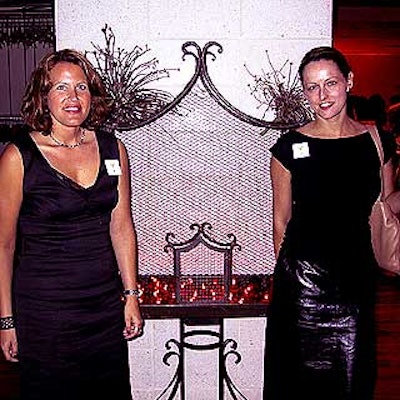Jes Gordon and Suzanne Yount of J. Gordon Designs provided the flowers and decor, including this black iron birdcage with red votive candles, for the event.