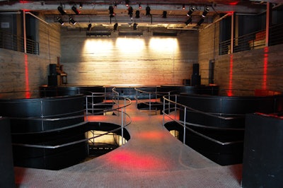 The main room of Galapagos Art Space features seating areas suspended above a 1,600-square-foot pool of water.