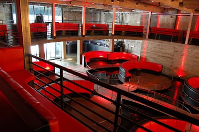 Overlooking the stage, the mezzanine holds more red banquettes as well as small lounge nooks.