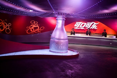The Shuang Experience Center's reception area sits under a blanket of gauzy fabric, springing from one of the many oversized Coke bottles.