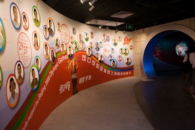 A wall detailing Coca-Cola's relationship with China bears statistics about the number of plants in operation and Chinese workers employed domestically.