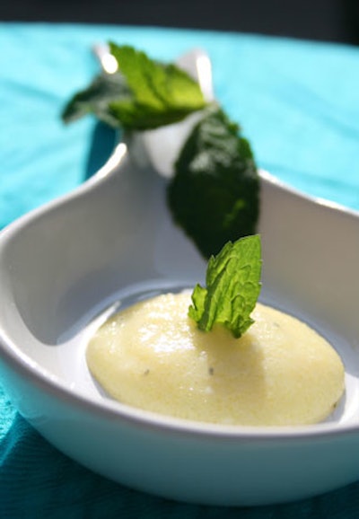 A mojito orb served on an Asian-style spoon features the traditional rum, sugar, and mint enclosed in a thin membrane, which bursts once placed in the mouth.
