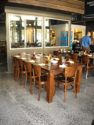 The restaurant's 150-seat dining room mixes walnut tables with large wooden wall panels salvaged from barns.