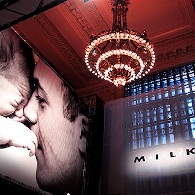 Blowups of photographs from the 'M.I.L.K.' (Moments of Intimacy, Laughter and Kinship) photography exhibit and a white logoed scrim stood at the entrance of Vanderbilt Hall for the exhibit's launch party.