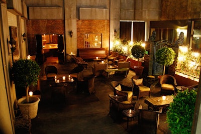 The venue features rattan seating and brick walls.