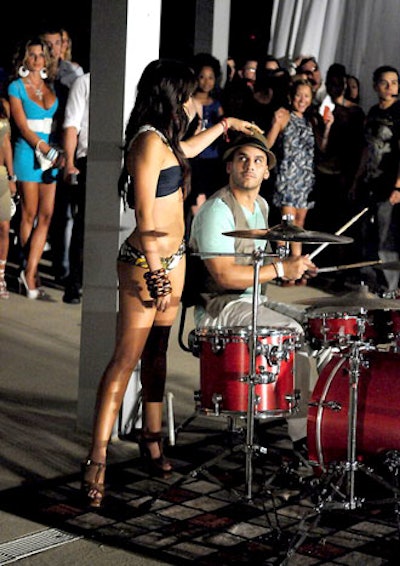 A drummer performed at the end of the runway during the final fashion show, for Kristina Ashley Swimwear.