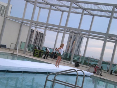 Before the show began, models practiced walking on the pool-spanning runway, as they posed for photographers who would be surrounding them on all sides during the show.