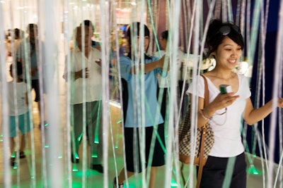 Entry to the pavilion requires guests to traverse a foyer covered in strands of lights.
