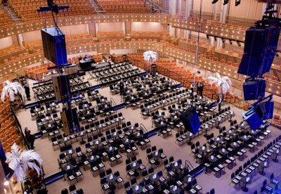 Chairs were arranged in a cabaret-style setup on a platform built over the concert hall's traditional fixed seating.