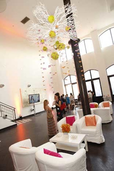 Plush white chairs piled with pink and orange pillows formed temporary lounges.