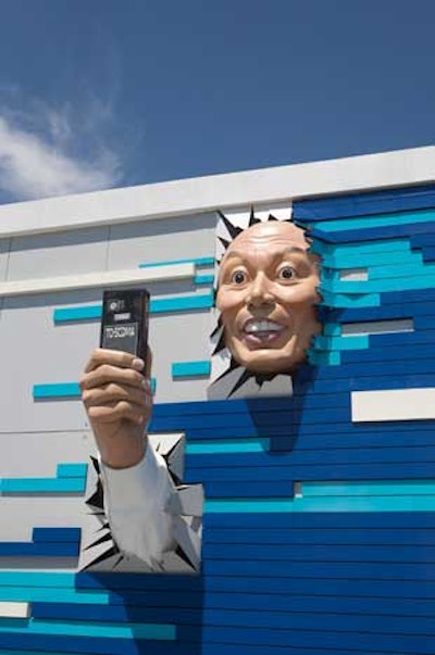 The face of an oddly excited man holding a cell phone also adorned the China Mobile pavilion.