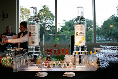 Bartenders poured the ingredients for a 'Summer Rain' martini through a Ketel One ice luge; guests placed martini glasses at the bases of the icy bottles to catch their drinks.