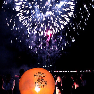 At the end of Elite's Model Look USA event, guests watched a colorful fireworks display by Bay Fireworks from the deck of the Intrepid, where a lighted balloon from Special Events Available Light showed the event's logo.