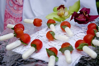 Passed hors d'oeuvres from Windows Catering included tomatoes skewered by a plastic injector filled with liquid mozzarella.