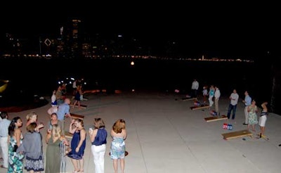 Chicago Cornhole, a local bean bag league, set up a tournament on the Adler Planetarium's terrace with the city skyline serving as a backdrop.