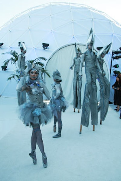 Stilt walkers and dancers dressed in silver hues greeted guests and circulated around the estate later in the evening.