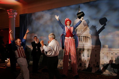 Uncle Sam-attired stilt performers from Cast of Thousands entertained guests with ring tosses as they waited to have photos taken.