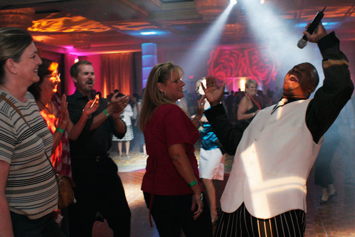Pink, blue, purple, and yellow gobo spotlights rotated around the dance floor while World Premier Band performed.