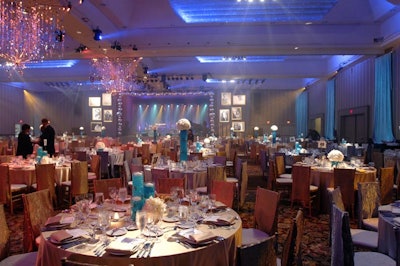 A mixture of high and low centrepieces and gold and silver satin linens gave variety to the room.