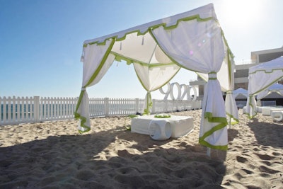 Green and white cabanas dotted the beach.