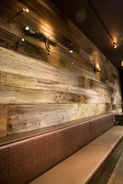 To achieve a rustic vibe, designer Kevin Heisner paneled the walls in reclaimed barn wood.