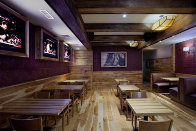 Exposed wooden beams, hickory accents, and equine artwork offer an upscale, outdoorsy feel.