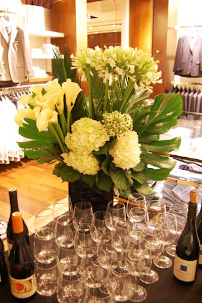 Arrangements of white lilies and hydrangeas topped two bars positioned outside the boutique.