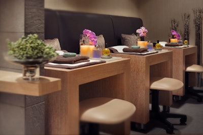 Nail services are performed in a separate area adorned with fresh flowers.