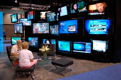 An assortment of flats-creen TVs decorated the walls of DirecTV's space.