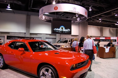 Passersby were invited to take photos with a Dodge Challenger at the Chrysler setup.